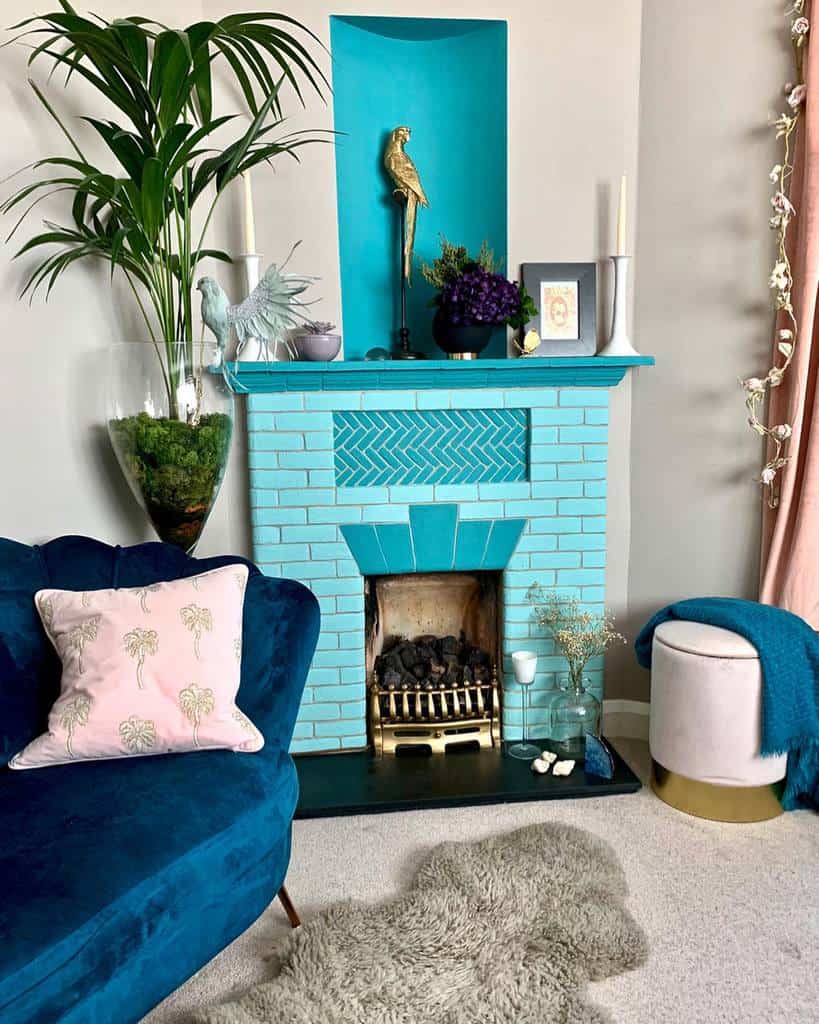 blue brick and tile fireplace gold bird statue blue sofa with pink cushion 
