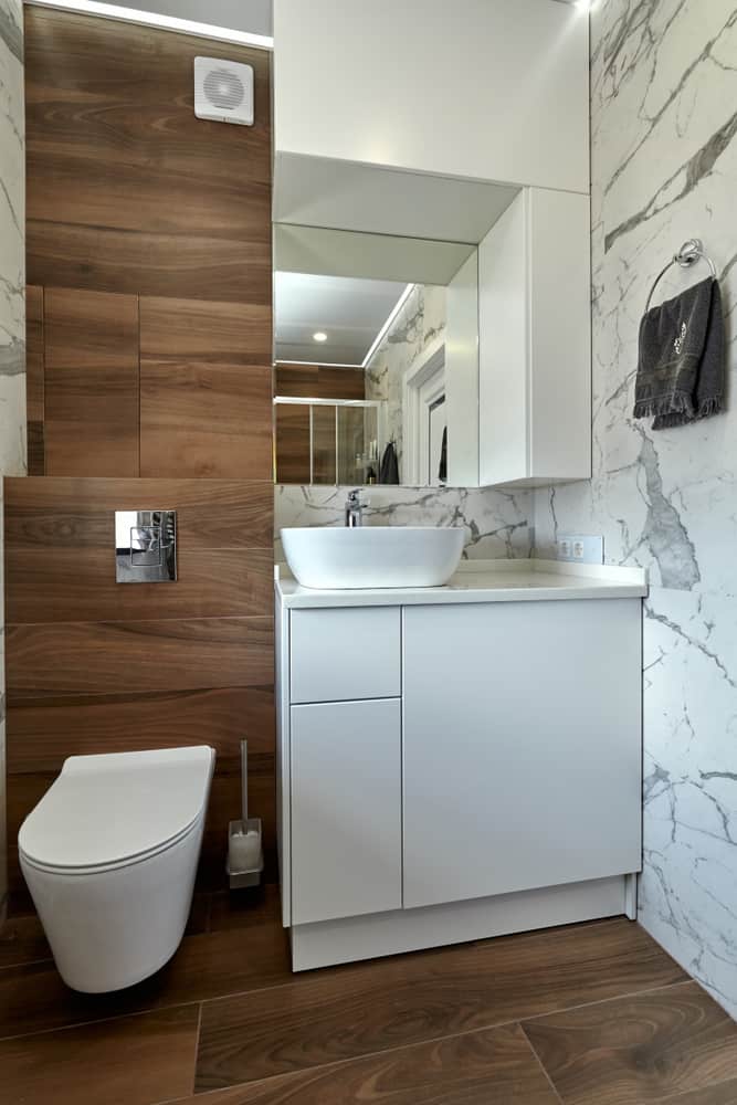 contemporary small master bathroom with marble walls and wood panels 