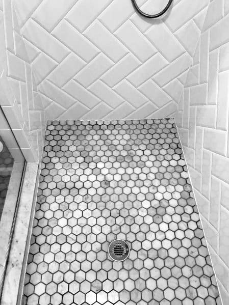 white wall tile shower with mosaic floor 