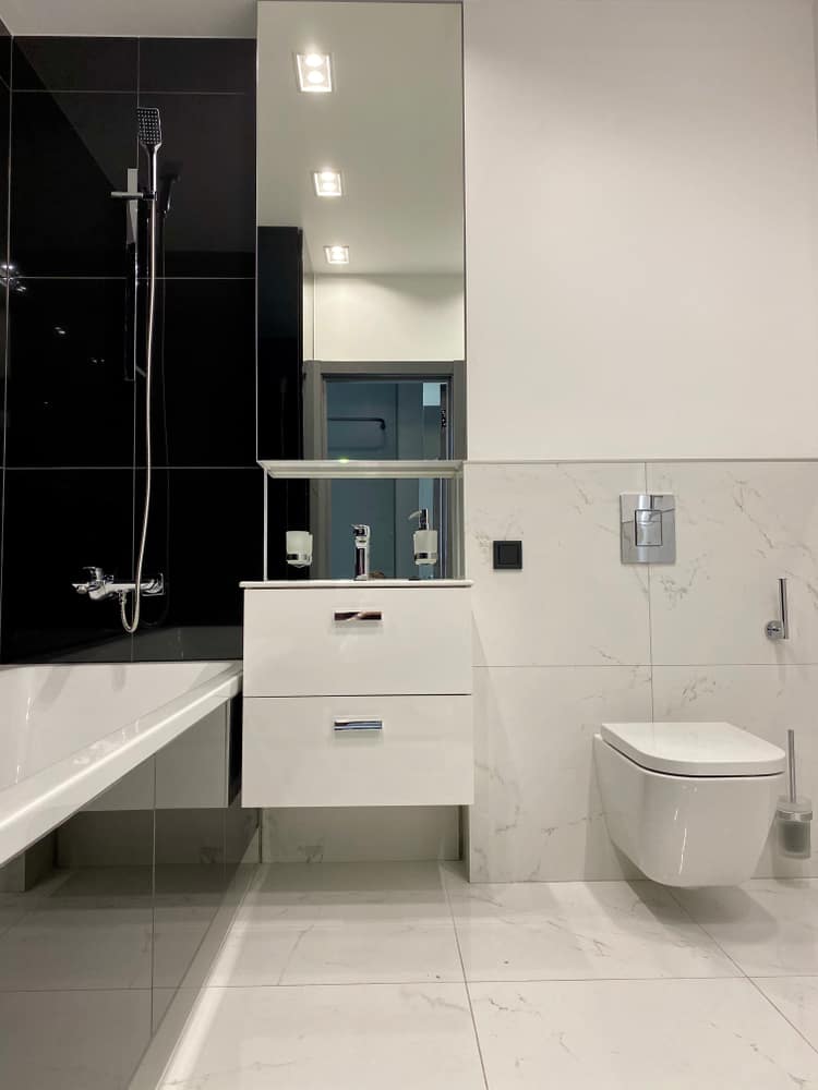 simple white small master bathroom with floating toilet 