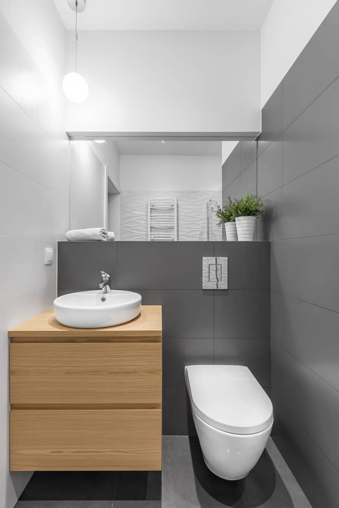 sleek contemporary basement bathroom with grey tiles