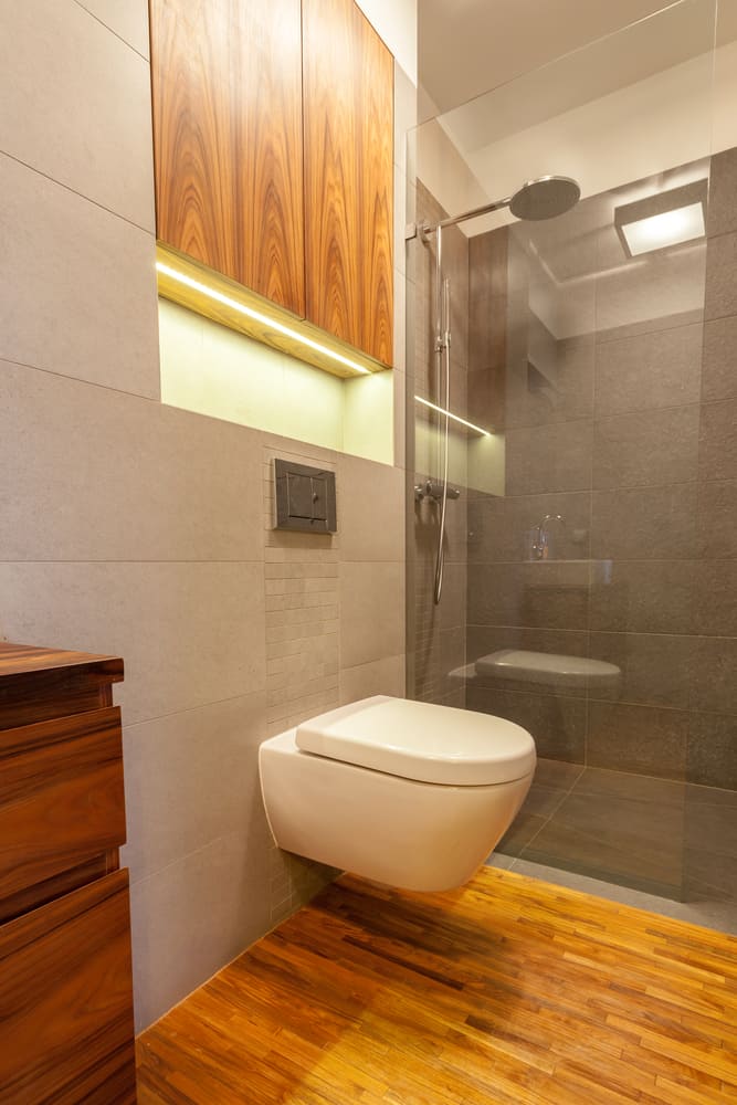 modern small master bathroom with floating toilet and glass shower 