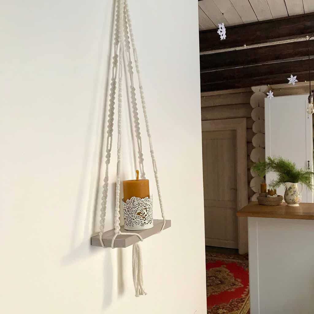 small hanging wood wall shelf with candle