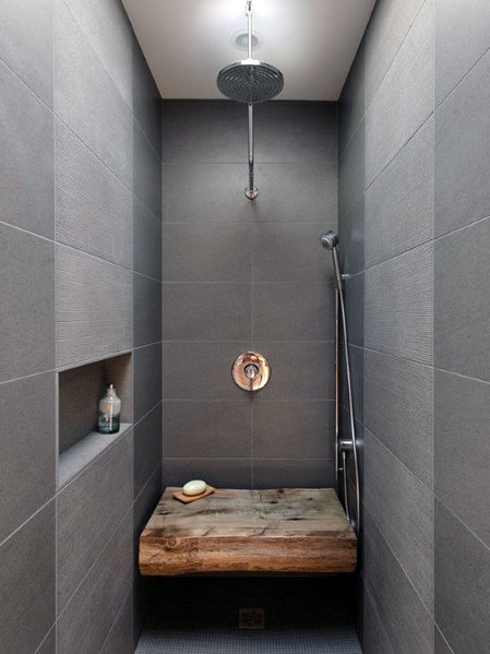 small gray tile narrow shower with wood bench 