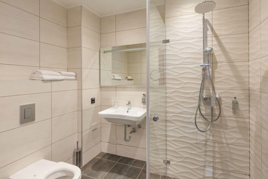 white tile bathroom with shower 