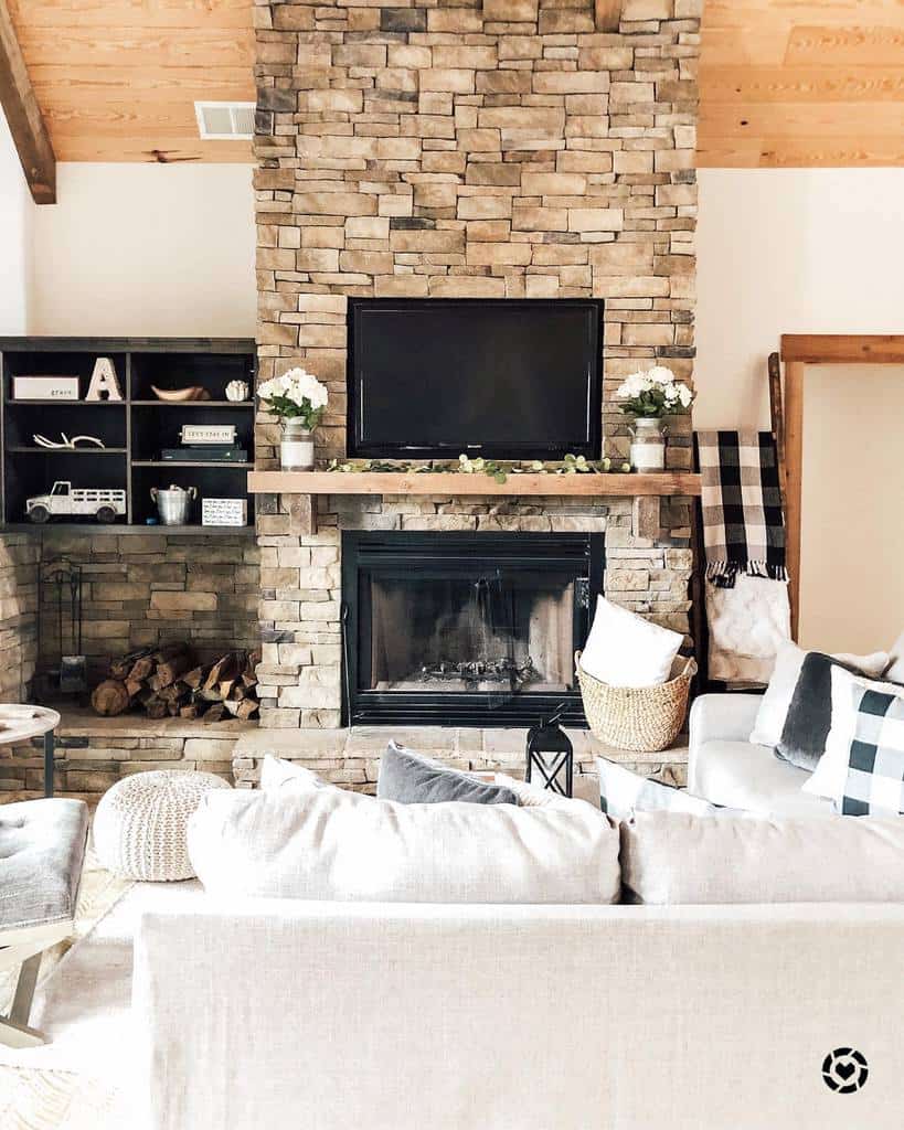 rustic living room stone fireplace white sofa wall mounted tv 