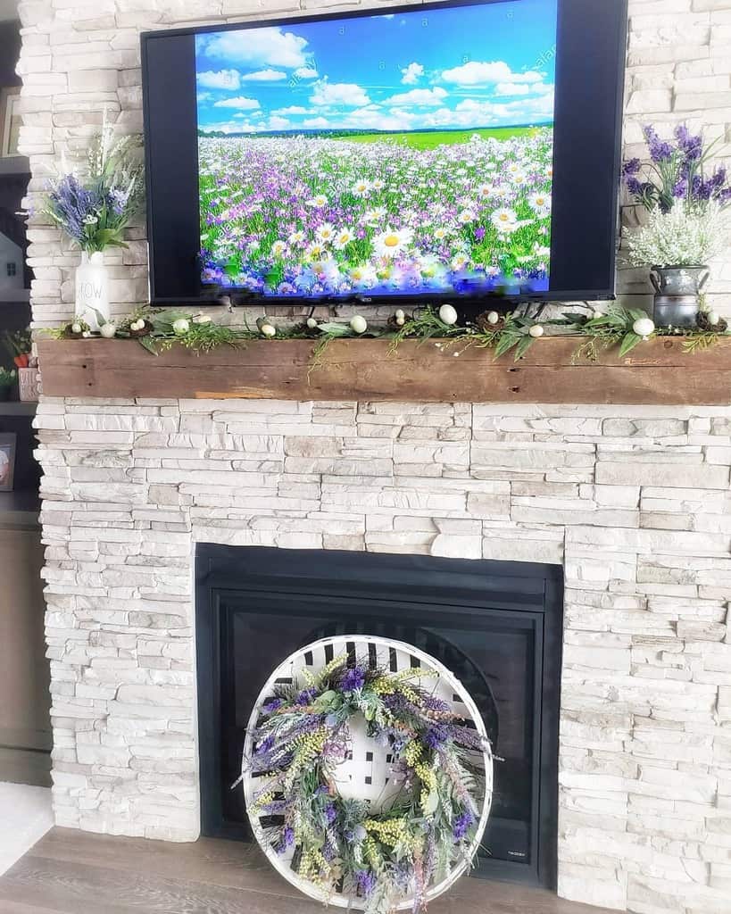 stone fireplace wood beam mantle wall mounted tv lavender 