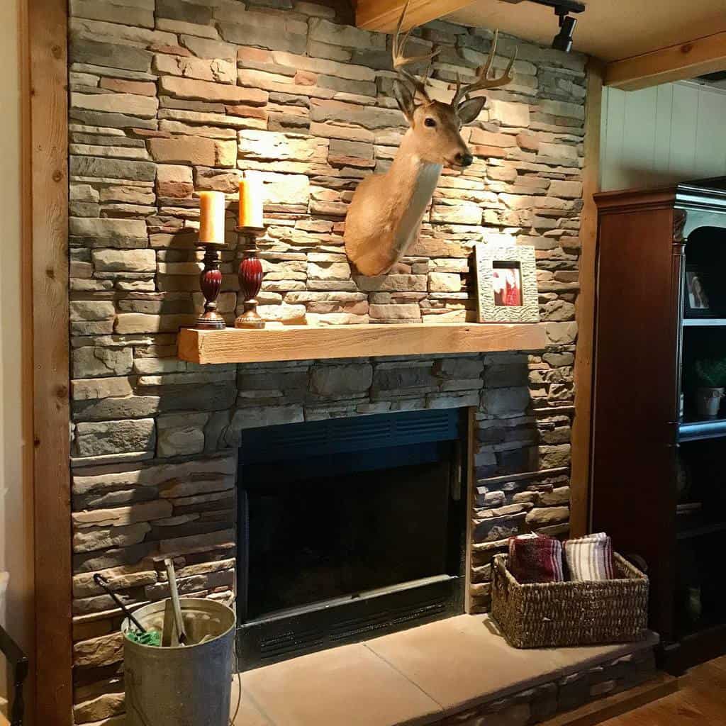 stone fireplace wood beam mantle mounted deer head 