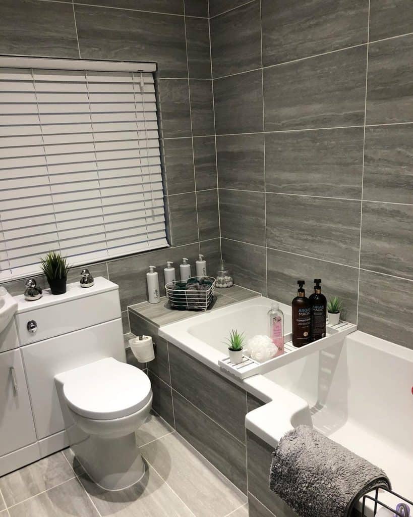 large gray tile small master bathroom with tub