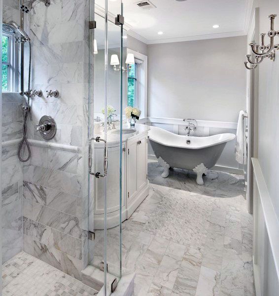 luxury bathroom with claw tub and marble walls 