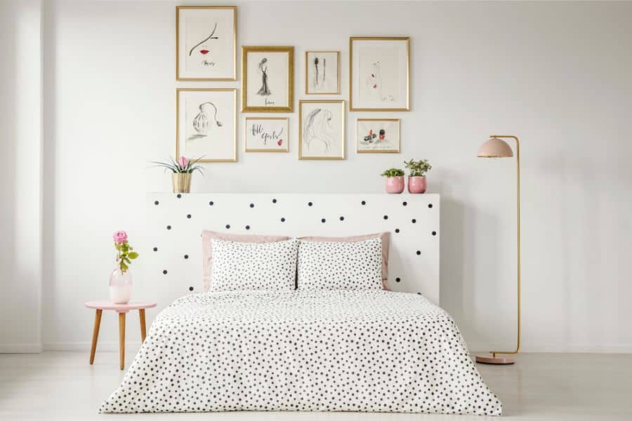 minimalist kids bedroom polka dot bedspread framed wall art pot plants 