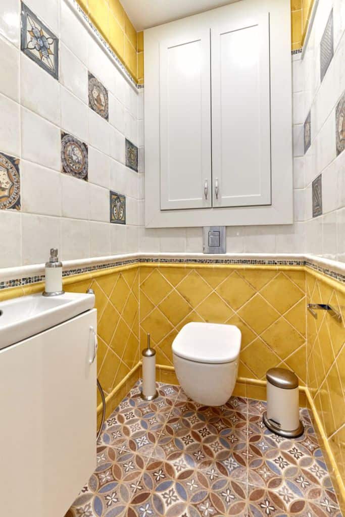 small powder room with yellow tiles 
