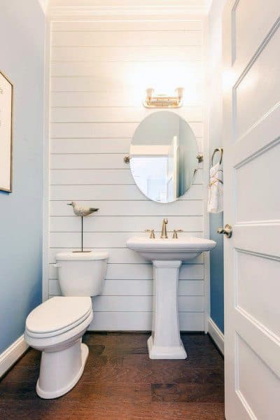 white shiplap accent wall small powder room 