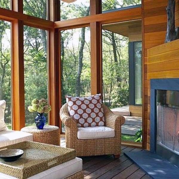 traditional sunroom with wood walls and fireplace