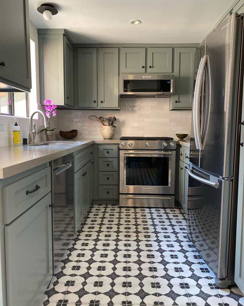 small u-shape kitchen green cabinets pattern floor tiles white tile backsplash 