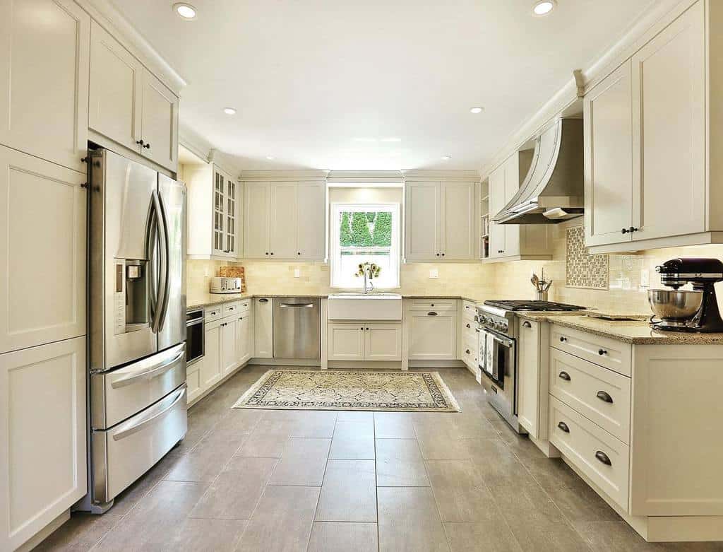 large open rustic kitchen white cabinets tile flooring 
