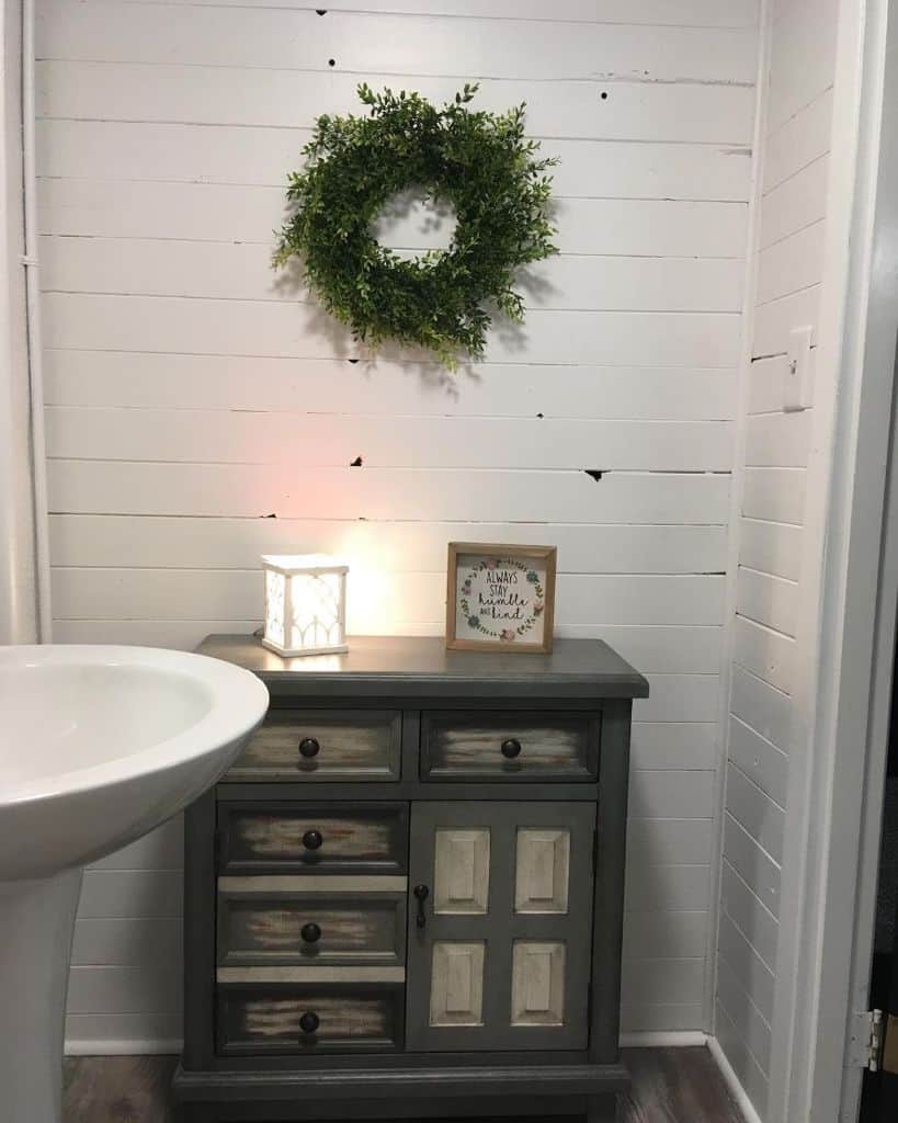 white bathroom with wood cabinet 