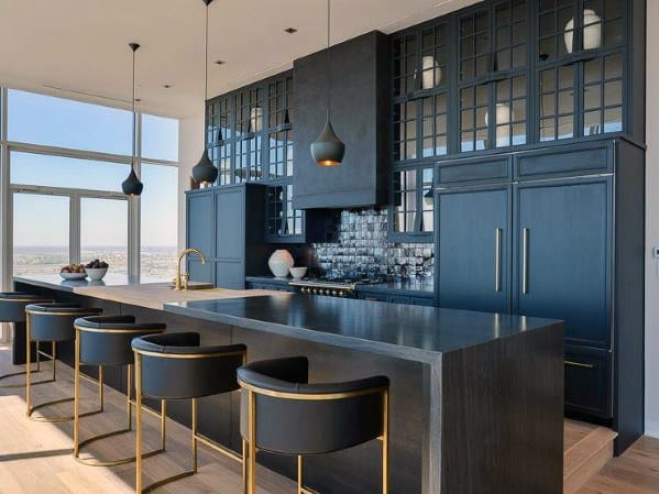 modern luxury black kitchen long island with black and gold stools 