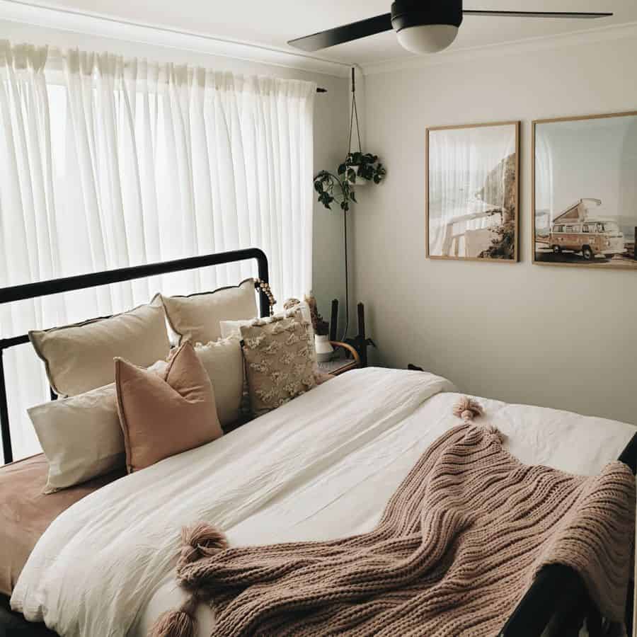 vintage small master bedroom with black bed frame 