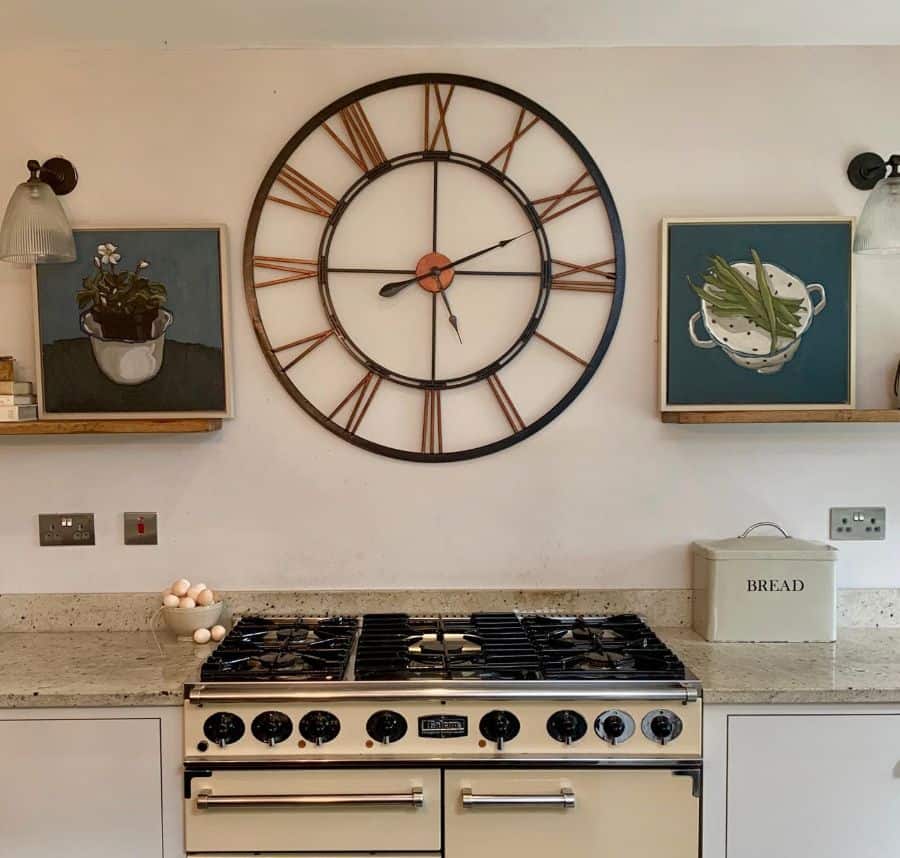 wall clock hanging over stove in kitchen 