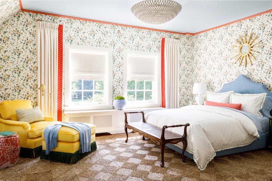 floral wallpaper in large bedroom with yellow accent chair 