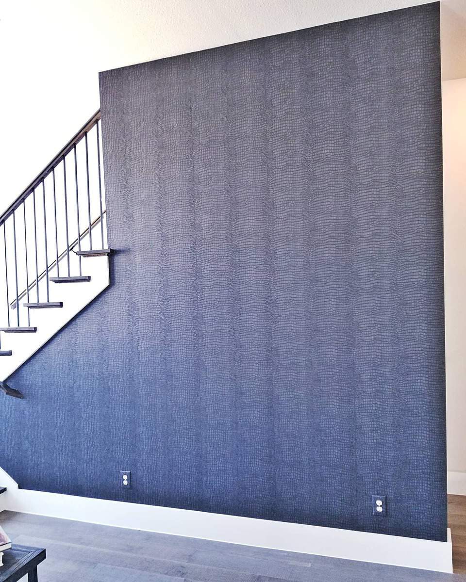 blue wallpaper accent wall on staircase 