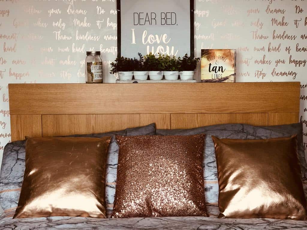 gold metallic wall lettering and bed cushions 