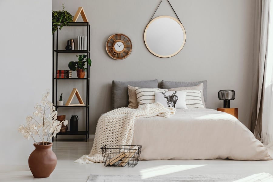 where to put a mirror in a bedroom white bedroom with circular mirror and black shelving unit 