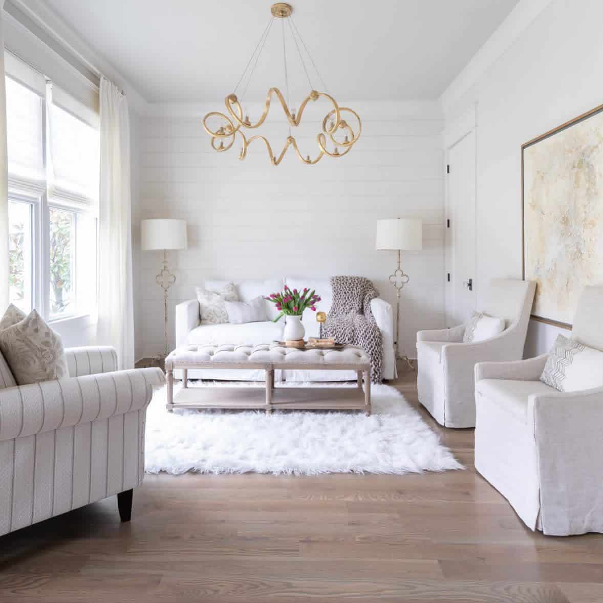 white living room white sofas and floor rug