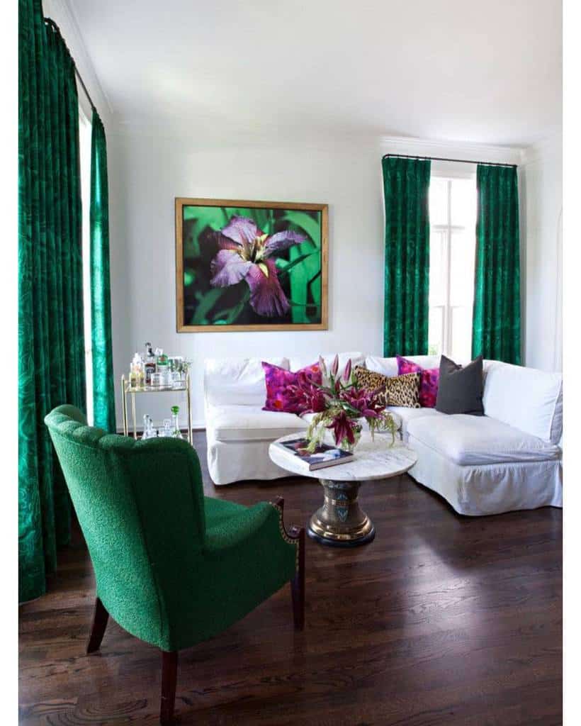white sofa green accent chair green curtains flower wall art
