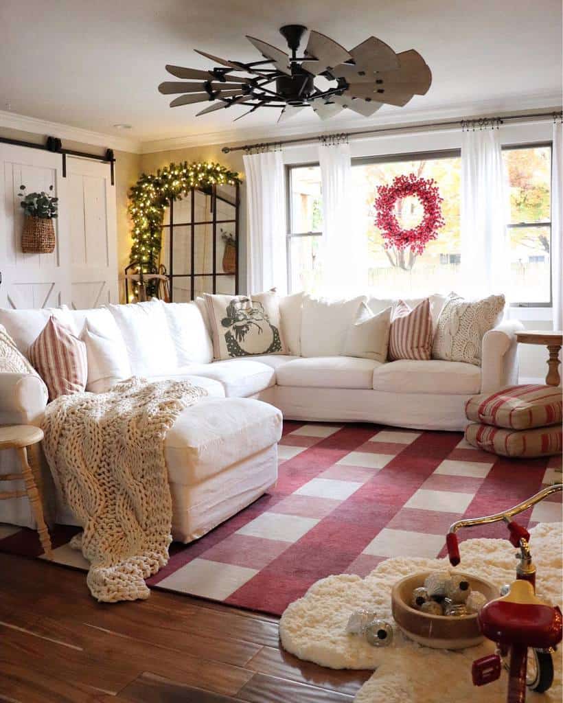 christmas theme living room white sofa red check floor rug fairy lights barn door 