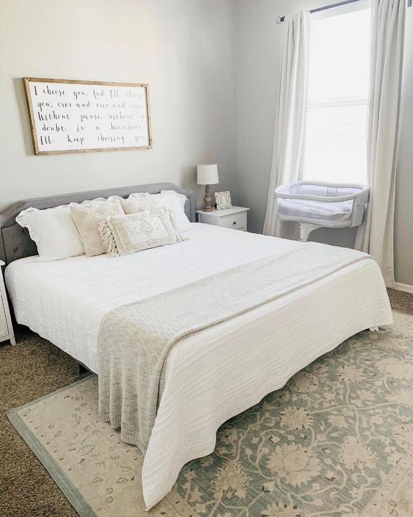 white small master bedroom with pattern floor rug 