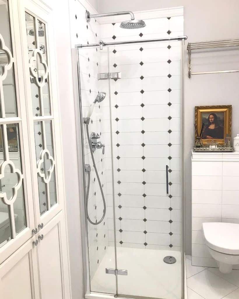 small white tile shower with mona lisa wall art