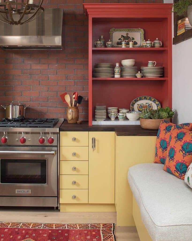 brick wall splash back red and yellow cabinets